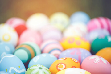 Collection of colorful easter eggs on green grass to celebrate Easter or spring.
