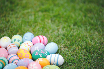 Collection of colorful easter eggs on green grass to celebrate Easter or spring.
