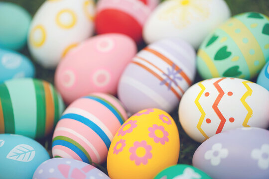 Collection of colorful easter eggs on green grass to celebrate Easter or spring.