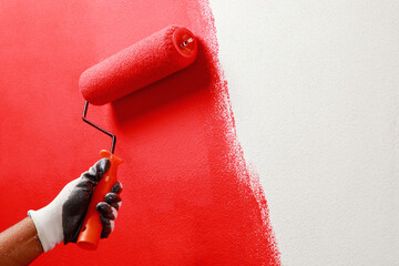 Roller Brush Painting, Worker painting on surface wall  Painting apartment, renovating with red...