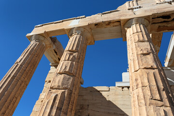 Fototapeta na wymiar Up view to The Propylaea columns, the monumental gateway that serves as the entrance to the Acropolis.