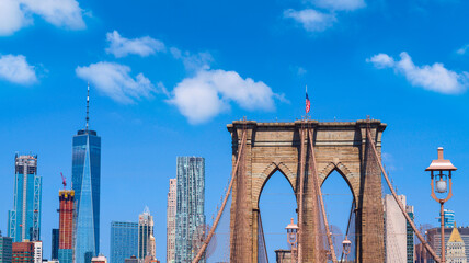 New York city Lower Manhattan skyline with Brooklyn Bridge over blue sky background