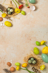 Easter holiday vertical border frame background with easter eggs and spring flowers. Top view, flat lay composition - 754676381