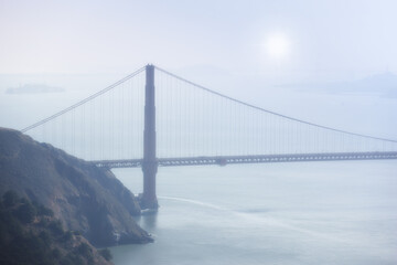 Golden Gate bridge, fog and ocean at sunrise by road, infrastructure or architecture in nature....