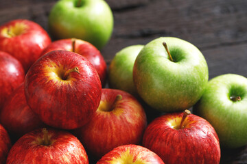 fresh red and green apples on the wooden floor