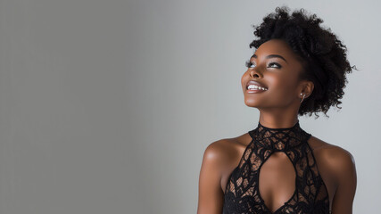 Afro elegant woman in black halterneck dress isolate on gray