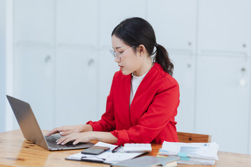 Asian businesswoman are stressed and tired from work sitting at desk in the office, feeling sick at work, stress from work.	