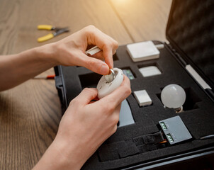 A technician works with a demo kit of the smart home system