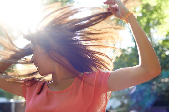 Woman, dancing or happy in nature with energy, wellness or celebration for fresh air in forest. Person, dancer or creative with body movement for fitness, fun or outdoor adventure on summer vacation