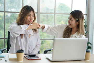 Two young Asian women, roommates wearing white shirts, working from home, successful partners,...