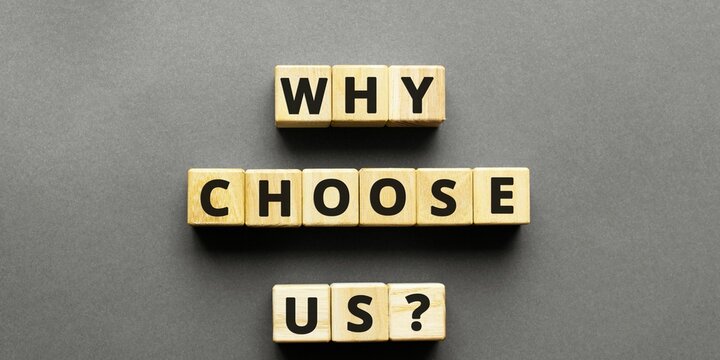 Word WHY CHOOSE US ? made with wood building blocks,