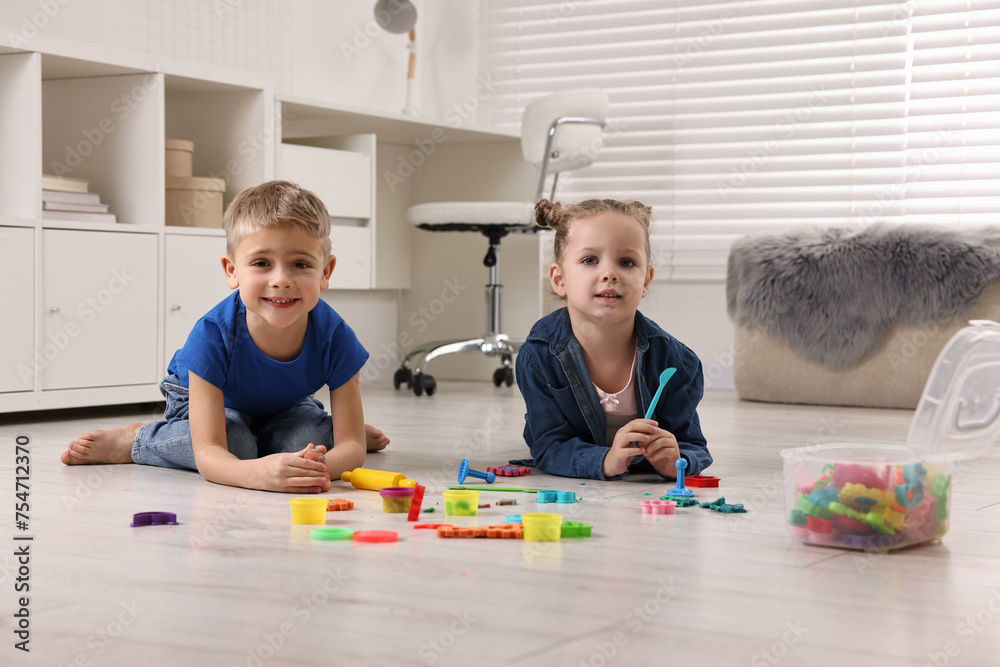 Canvas Prints Cute little children playing on warm floor at home. Heating system