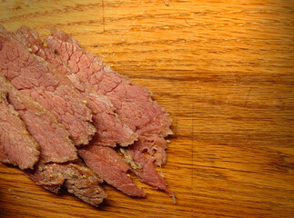 Freshly, multi-cooker prepared (90 minutes), corned beef (salt beef) on an oak cutting board for Corned Beef and Cabbage, Irish Boiled Dinner, Reuben Sandwich or Corned Beef Hash 