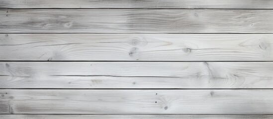 Fototapeta premium A black and white photograph of a weathered wooden wall, showcasing its intricate textures and patterns in grayscale. The wood appears aged, with visible grains and cracks adding character to the