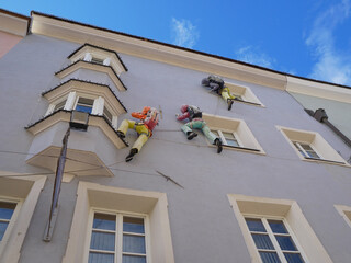 Fake Climbers, Mountaineers Along the Facade of a Building with Windows