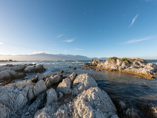 Golden Sunset Serenity: Kaikoura Coastal Walkway Landscape with clifftop views of the sea and mountains, South Island, New Zealand