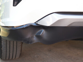 Vehicle bumper dent broken by car crash . Car insurance concept.
