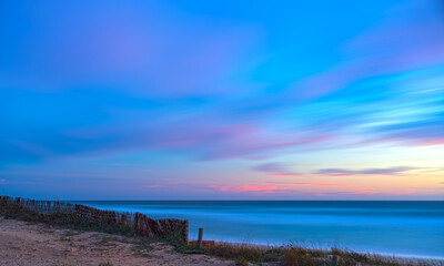 Abstract Beach Sunset with Pink and Blue Clouds, Silky Water and Cottony Sky
