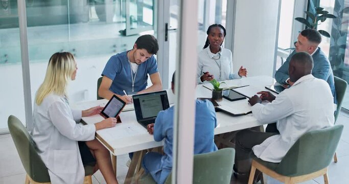 Medical, team and discussion for healthcare in conference room with technology, top view and meeting. Collaboration, doctor and nurse group in boardroom for surgery brainstorming and health planning
