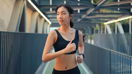 Fototapeta na wymiar Young asian woman runner is training in the summer sunset within a city, The athlete fit and firm girl exercising by jogging workout sport outdoor for her healthy wellness.
