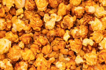 sweet popcorn in icing sugar, snacks, yellow background