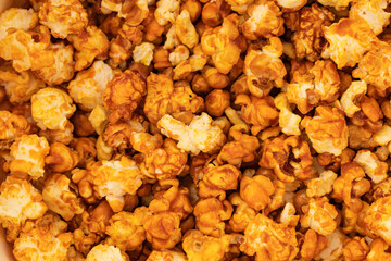 sweet popcorn in icing sugar, snacks, yellow background
