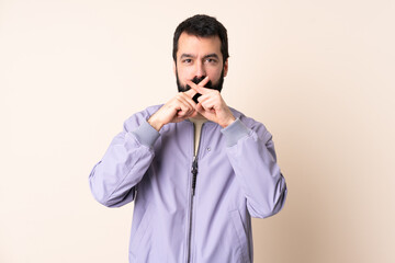 Caucasian man with beard wearing a jacket over isolated background showing a sign of silence gesture