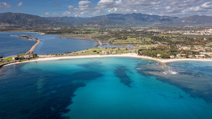 Panorama of the coast of Pula in Sardinia. Crystal clear sea and clouds in the distance