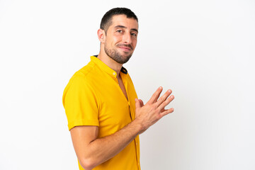 Young handsome caucasian man isolated on white background scheming something