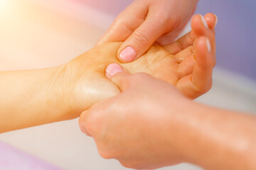 Facial massage. A woman is given a massage in a beauty salon. Close-up.
