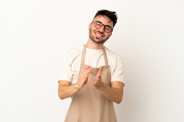 Restaurant waiter caucasian man isolated on white background applauding after presentation in a conference