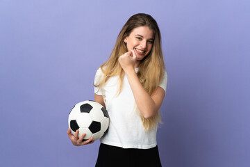 Young blonde football player woman isolated on purple background celebrating a victory