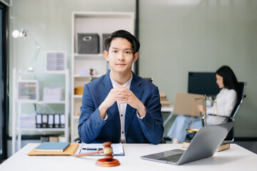 Asian man lawyer working and gavel, tablet, laptop in front, Advice justice and law concept...
