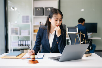 Asian woman lawyer working and gavel, tablet, laptop in front, Advice justice and law concept..