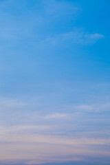 A tranquil sky with soft pastel hues, where the gentle transition from a rich blue to a subtle pink creates a peaceful gradient.