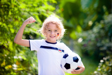 Germany football fan kids. Children play soccer.