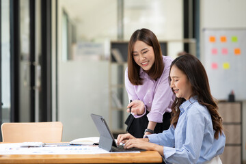 Asian business woman working and talking at the office
