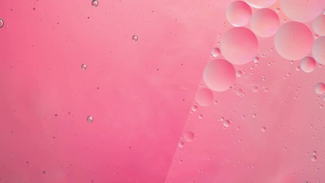 Abstract pink colorful background with oil on water surface. Oil drops in water abstract psychedelic, abstract image.
