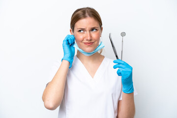 Dentist caucasian woman holding tools isolated on white background frustrated and covering ears