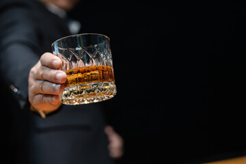 Bartender pours whiskey to customer in tavern