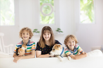 Kids play and watch tv on couch. Child at home.