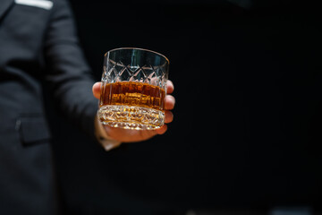 Bartender pours whiskey to customer in tavern