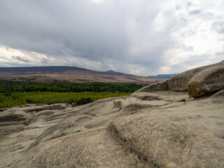 The uplistsikhe cave dwellings with the beautiful kura river, georgia. © benyapha