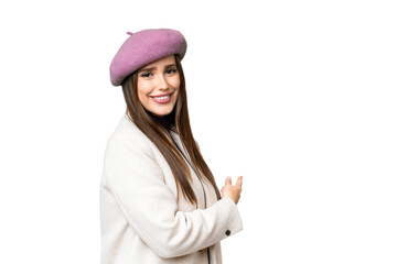 Young beautiful woman over isolated chroma key background pointing back