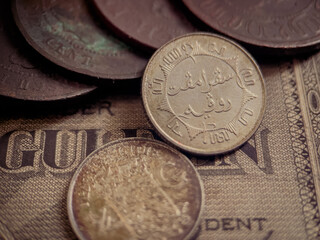 front and back view of an ancient quarter guilder coin.