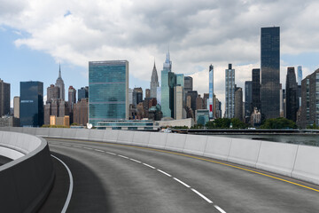 Empty urban asphalt road exterior with city buildings background. New modern highway concrete construction. Concept of way to success. Transportation logistic industry fast delivery. New York. USA.
