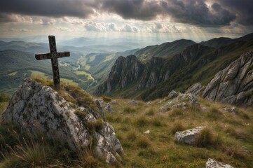 Cross on the top of the mountain with rays of light coming through the clouds - obrazy, fototapety, plakaty