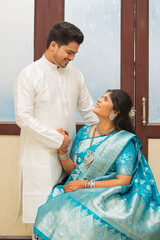 Cheerful young Indian couple in traditional wear