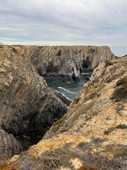 Fantastic rocky coast, cloudy sky, twilights time, ocean horizon