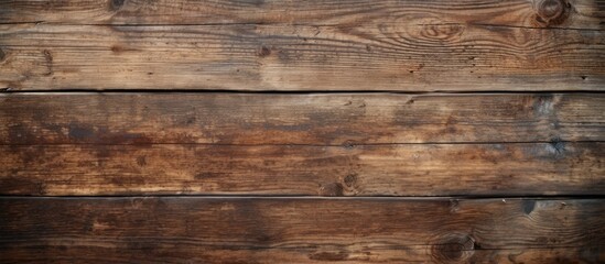 A close-up view of an aged brown wooden background with a sleek black border framing the edges. The texture of the wood is visible, showcasing its weathered and rustic appearance.